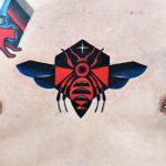 Colorful bee tattoo on the chest