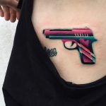 Colorful pistol tattoo