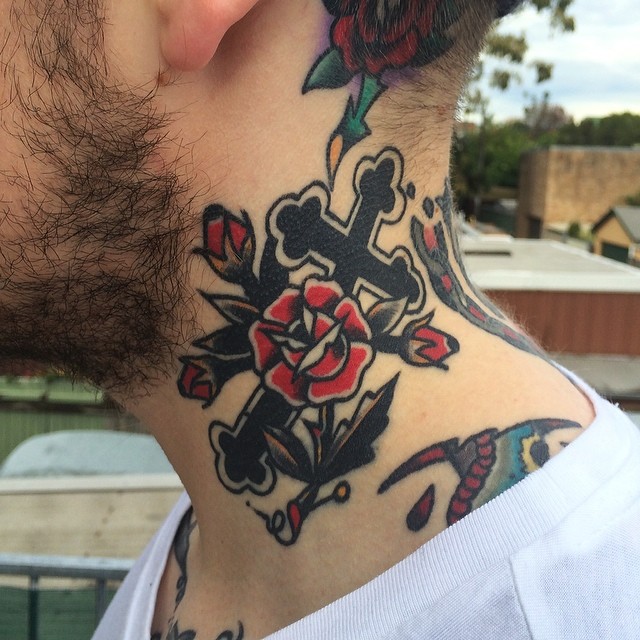Cross and rose tattoo on the neck