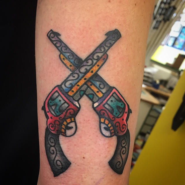 Crossed revolvers tattoo