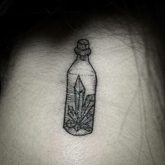 Crystals in a bottle tattoo