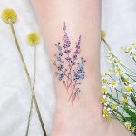 Delicate blue and violet wildflowers tattoo