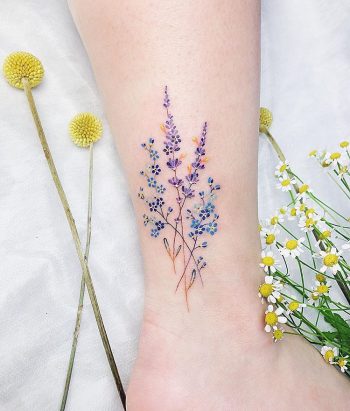 Delicate blue and violet wildflowers tattoo
