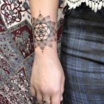 Dot work mandala and flower of life tattoo