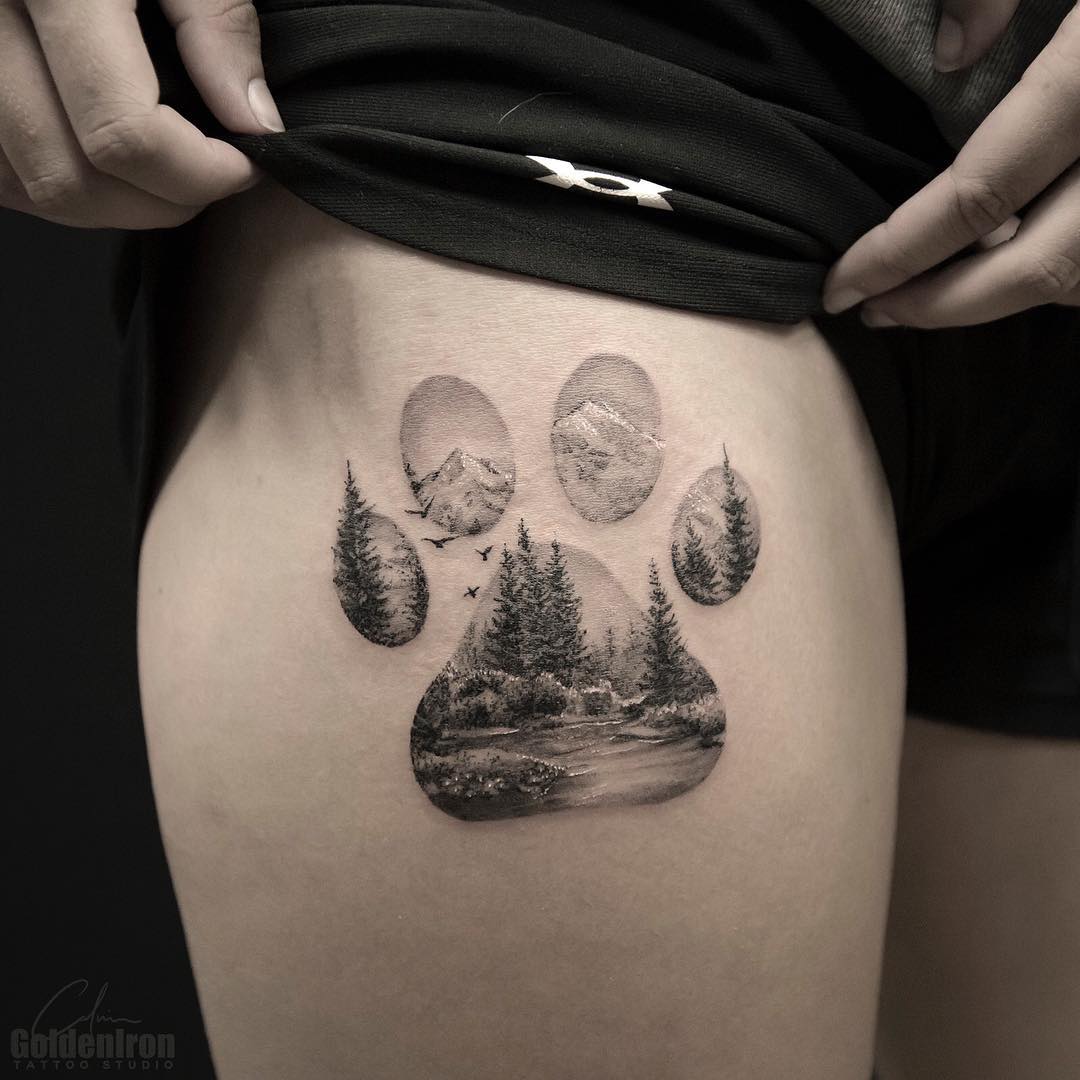 Double exposure paw and landscape tattoo
