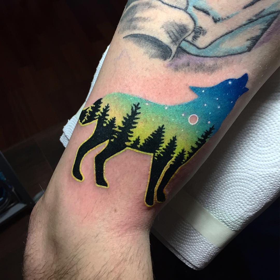 Double exposure wolf and landscape tattoo