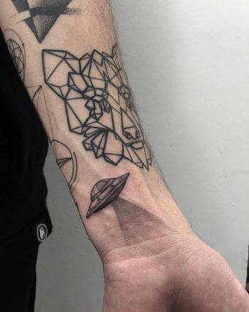 Flying saucer tattoo on the wrist