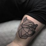 Geometric bear tattoo on the bicep