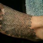 Geometric pattern tattoo on the left foot