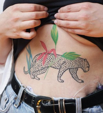 Geopard and plants tattoo on the belly