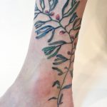 Green and red plant tattoo