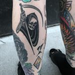 Grim reaper tattoo on the left calf