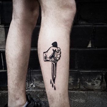 Hand holding knife tattoo