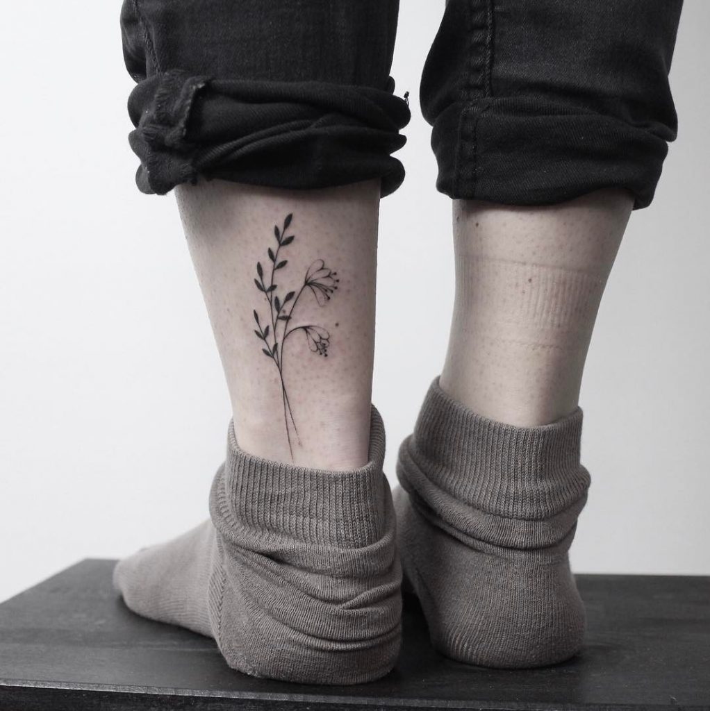Hand poked minimalist flower tattoo