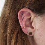Hand poked tattoo on the ear