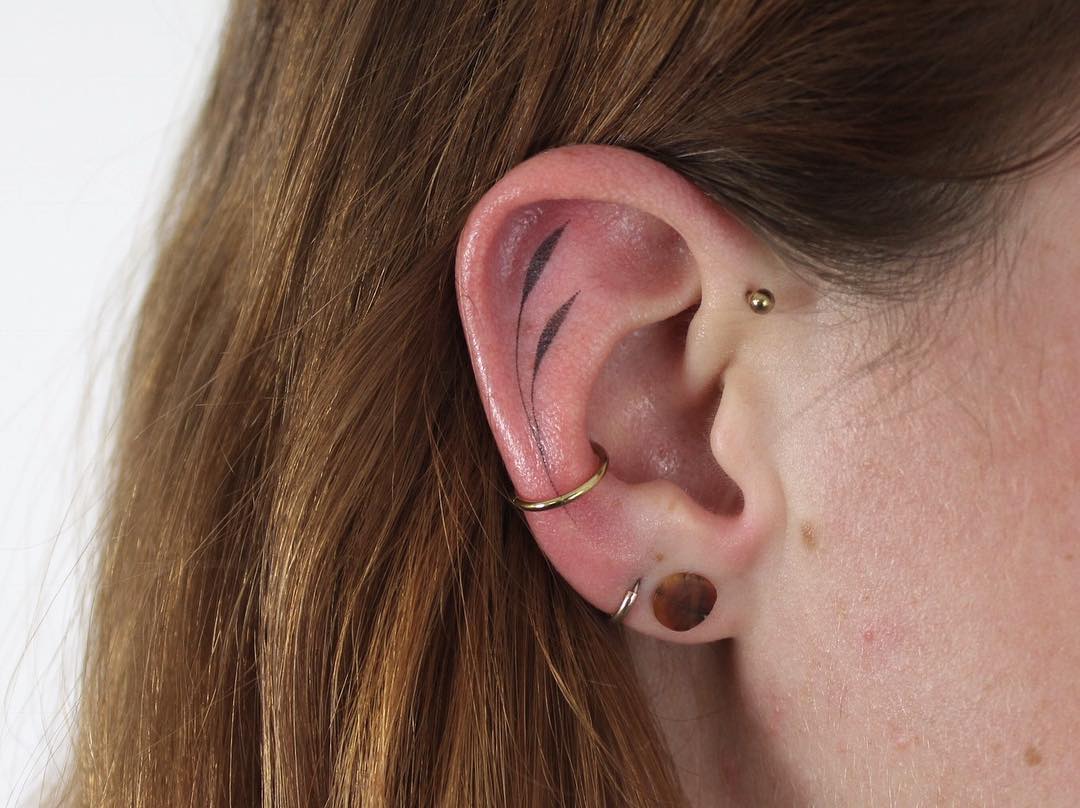 Hand poked tattoo on the ear