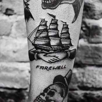 Handshake and ship tattoo