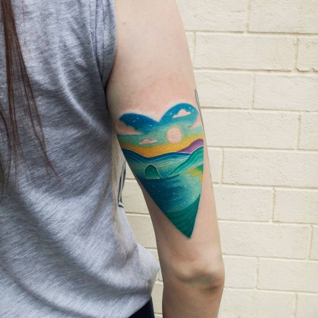 Heart shaped bluish landscape tattoo