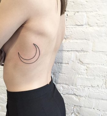 Linear crescent moon tattoo on the rib