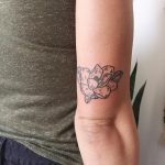 Little magnolia tattoo above the right elbow