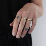 Little ornament tattoos on fingers