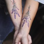 Matching lavender tattoos on forearms