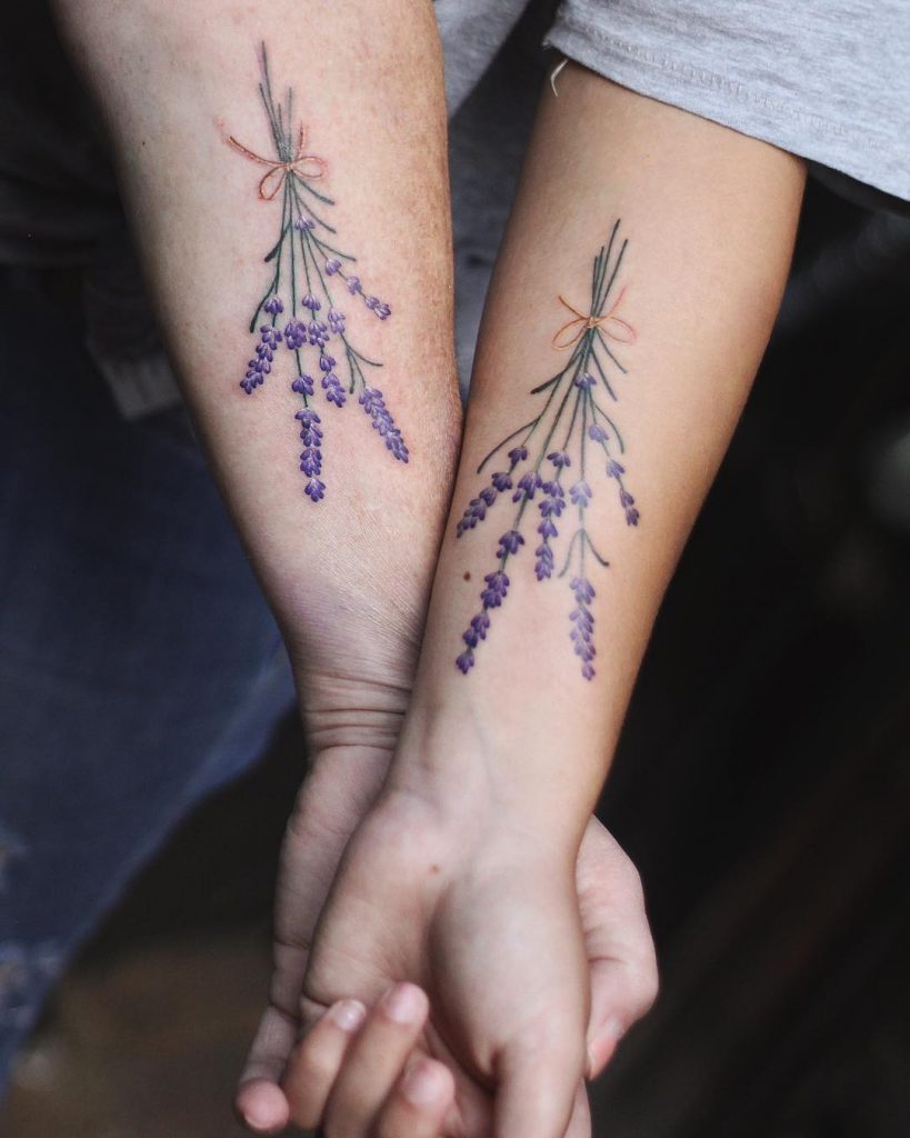 Matching lavender tattoos on forearms