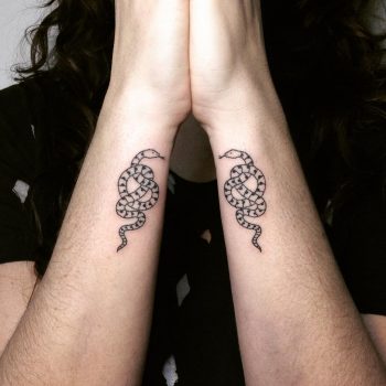 Matching snake tattoos