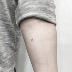 Micro airplane tattoo on the arm