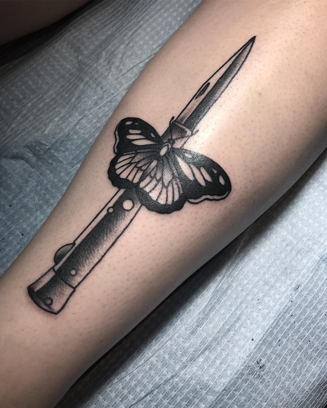 Moth and knife tattoo