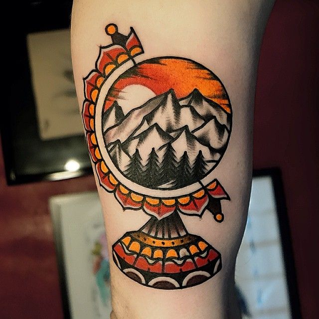 Mountainous globe tattoo