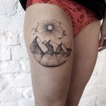 Mountains and lake tattoo on the thigh