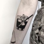 Negative space cocktail tattoo