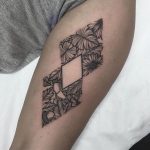 Negative space rhombus and tropical plants tattoo