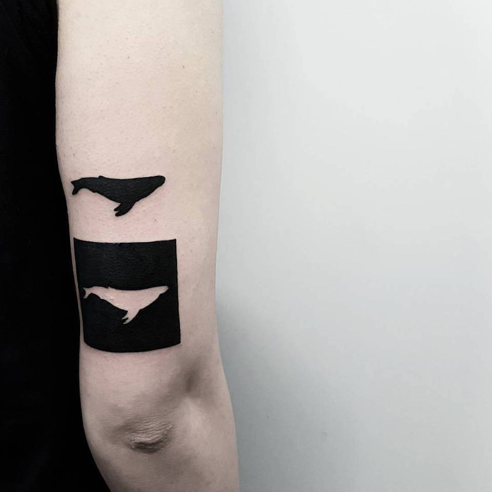Negative space whale tattoo