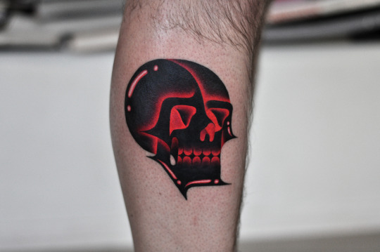 Neon skull tattoo on the calf