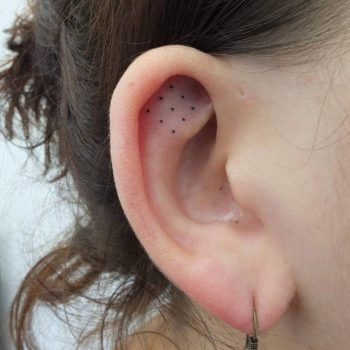 Nine dots tattoo on the ear
