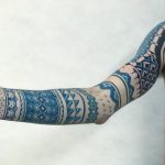 Ornamental blue sleeve tattoo