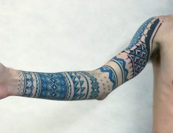 Ornamental blue sleeve tattoo