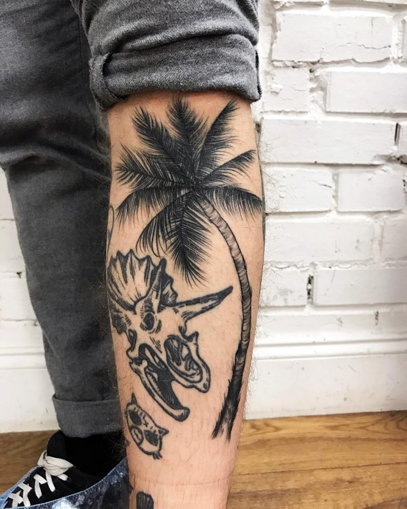 Palm tree and dino skull tattoo
