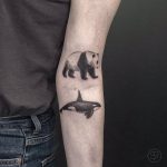 Panda and orca tattoo on the arm