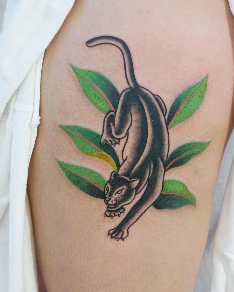 Panther and green leaves tattoo