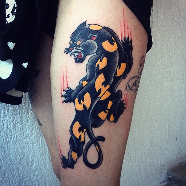 Panther with yellow patches tattoo