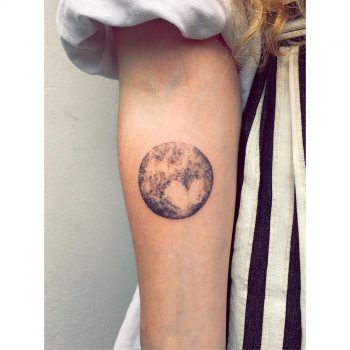 Pluto tattoo on the forearm
