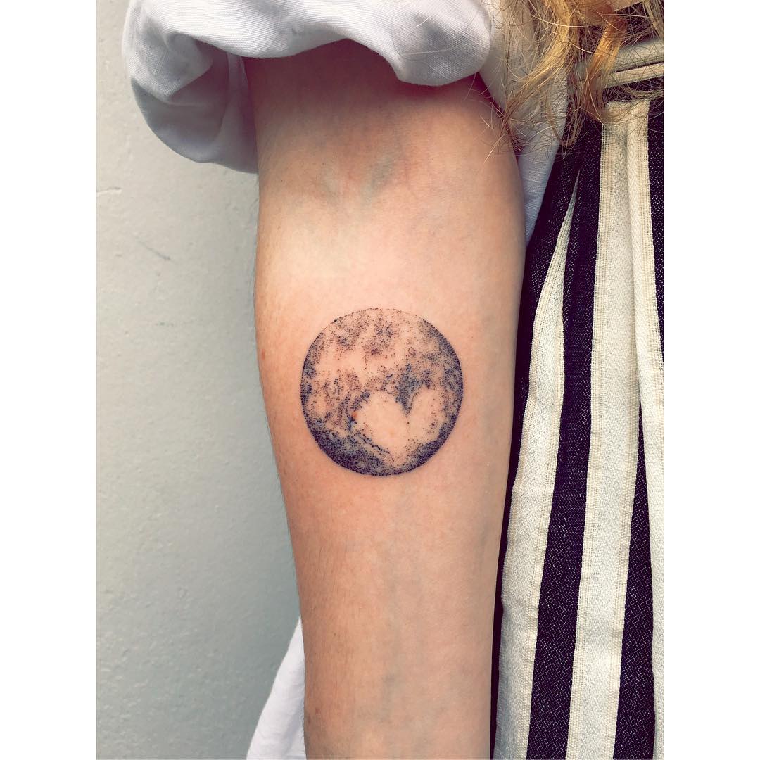 Pluto tattoo on the forearm