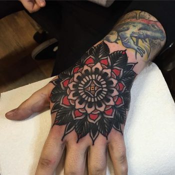 Red and black mandala hand tattoo