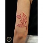 Red leaves tattoo on the arm