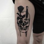 Rose and dagger stabbed skull tattoo