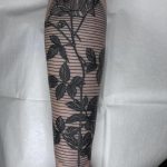 Rose and linear pattern tattoo