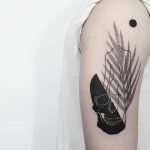 Skull and silhouette tattoo